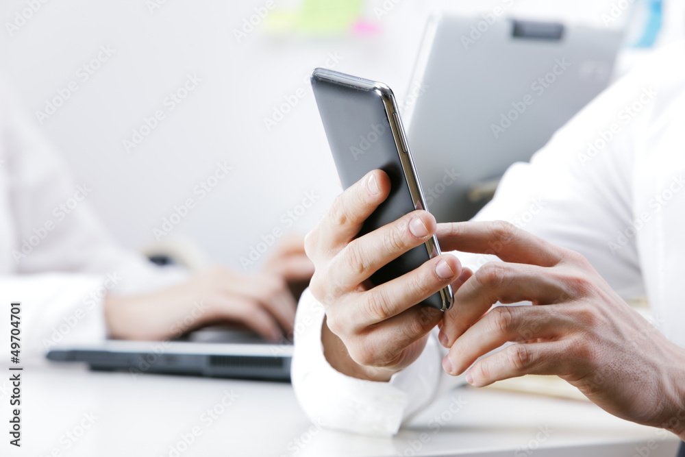 businessman using smart phone in office