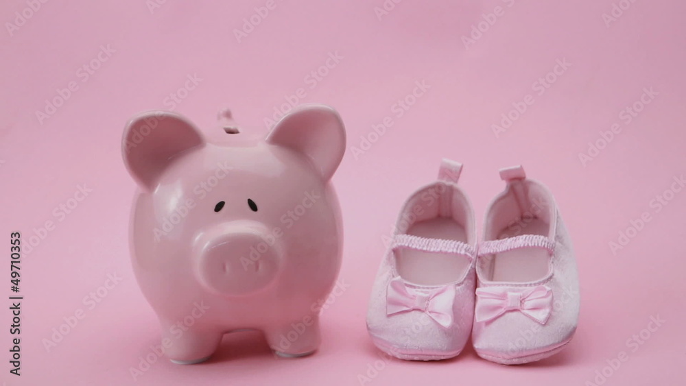 Hand dropping coin in piggy bank Hand dropping coin in piggy bank