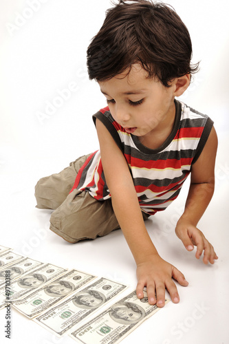 Cute little boy plays with money