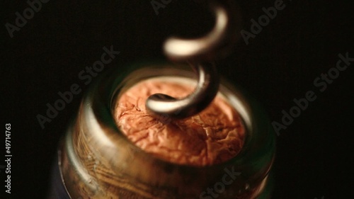 Bottle of wine being open with cork screw