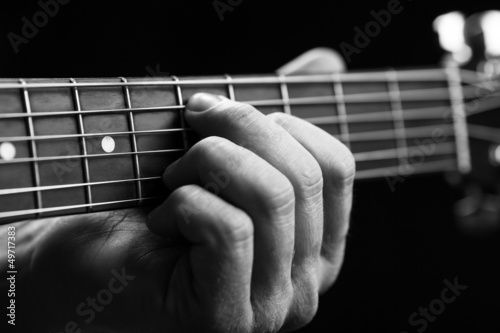 Brown guitar in hands in the guy playing it