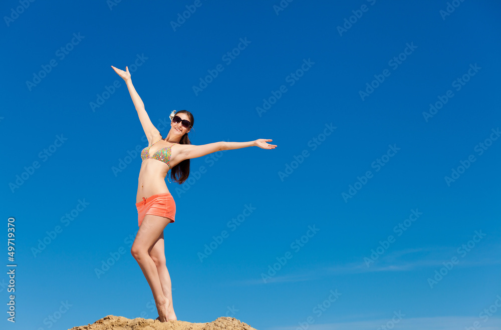 Portrait of young woman in bikini at beach