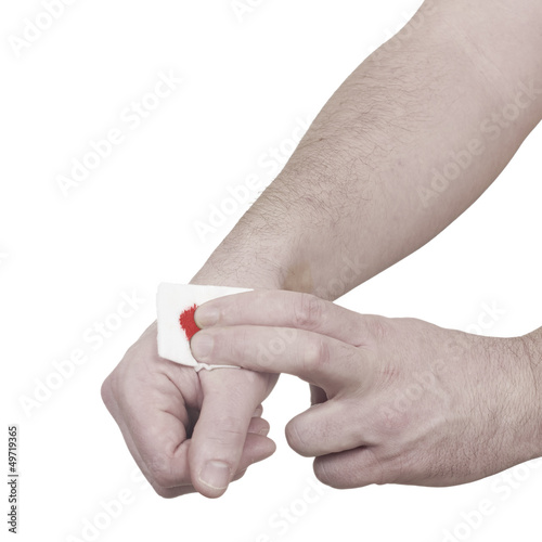 Hand with bloody bandage over wound