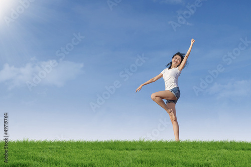 Attractive woman gesture on green field