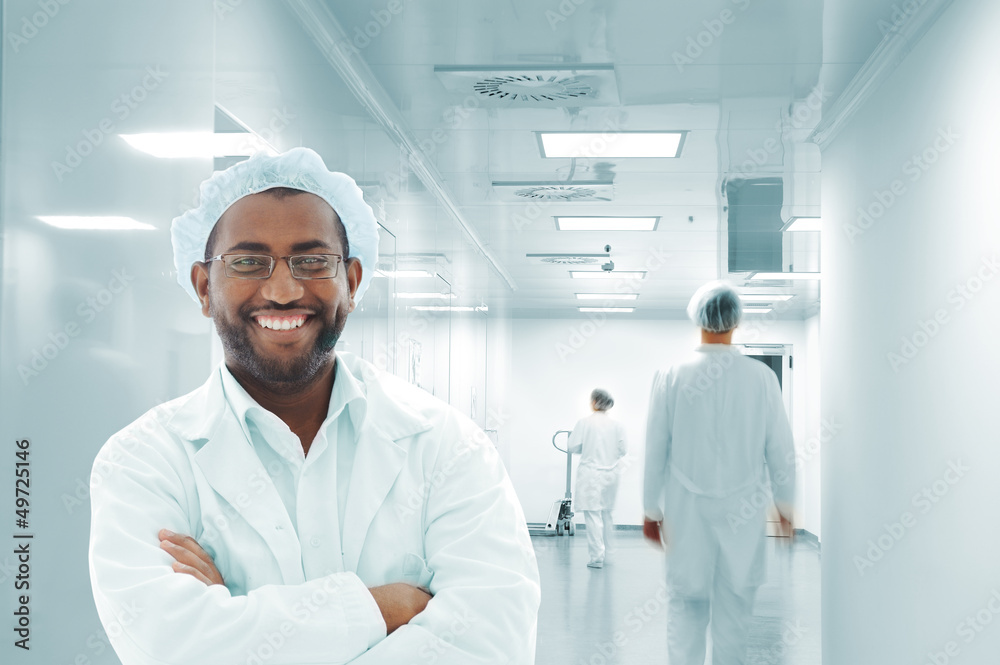 Working people with white uniforms in modern facility Working people with white uniforms in modern facility