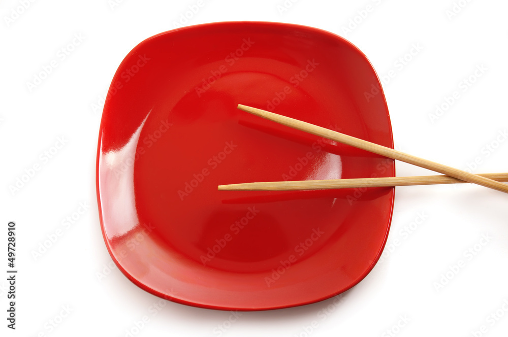 Red plate with chinese sticks Red plate with chinese sticks