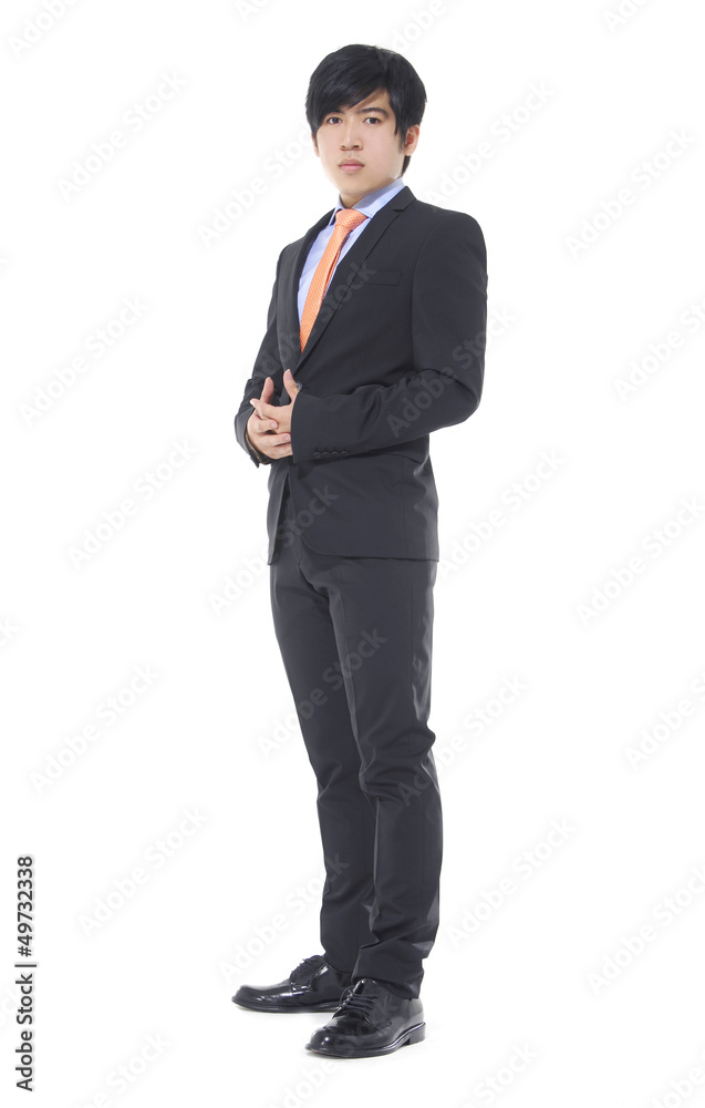 young business man standing with hands in pocket young business man standing with hands in pocket