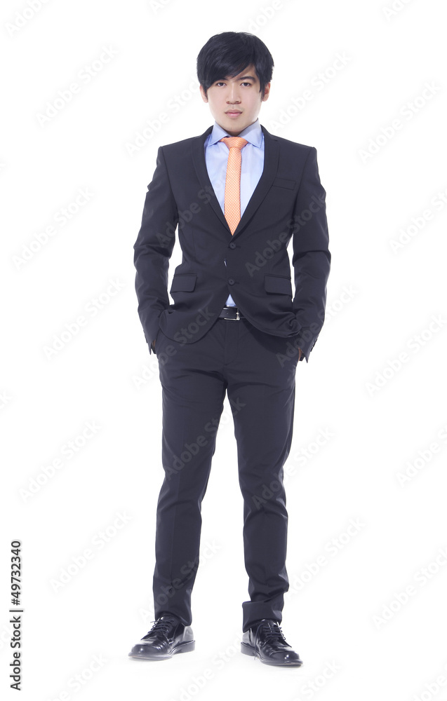 young business man standing with hands in pocket young business man standing with hands in pocket