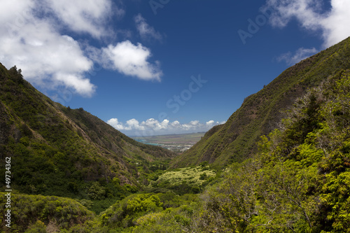 The city of Wailuku is visible between lush mountains