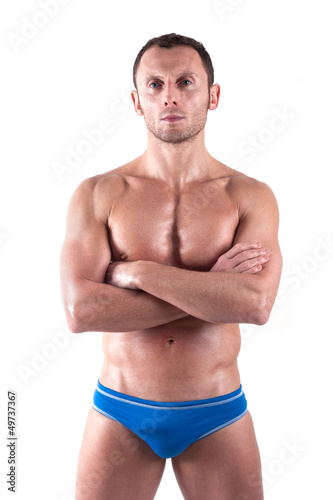 Young man wearing swimsuit isolated over white background.