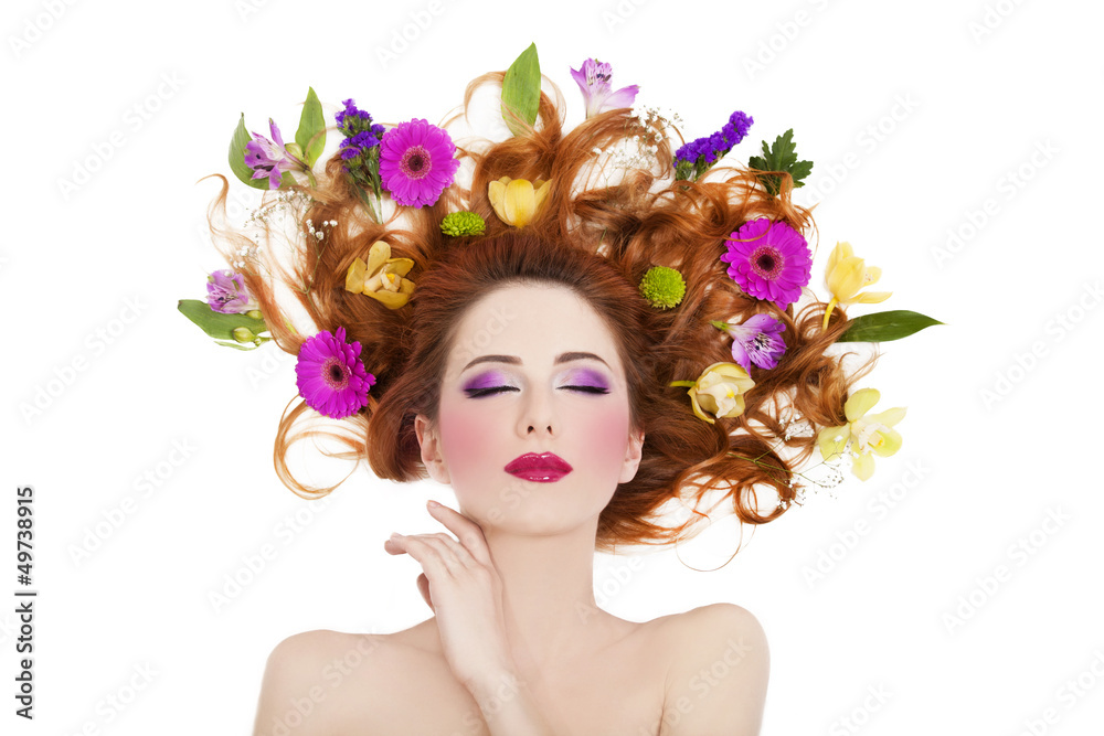 Beautiful redhead girl with flowers isolated.
