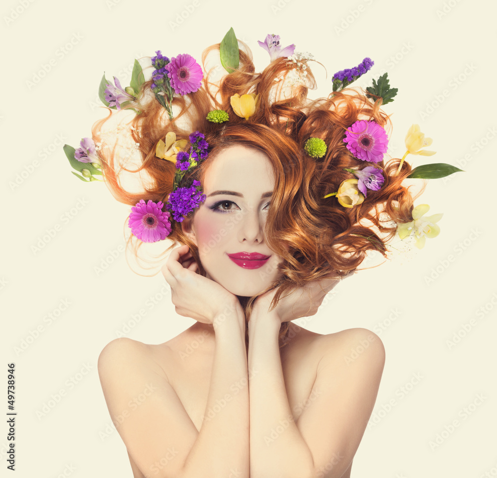 Obraz premium Piękna rudzielec dziewczyna z kwiatami odizolowywającymi.
