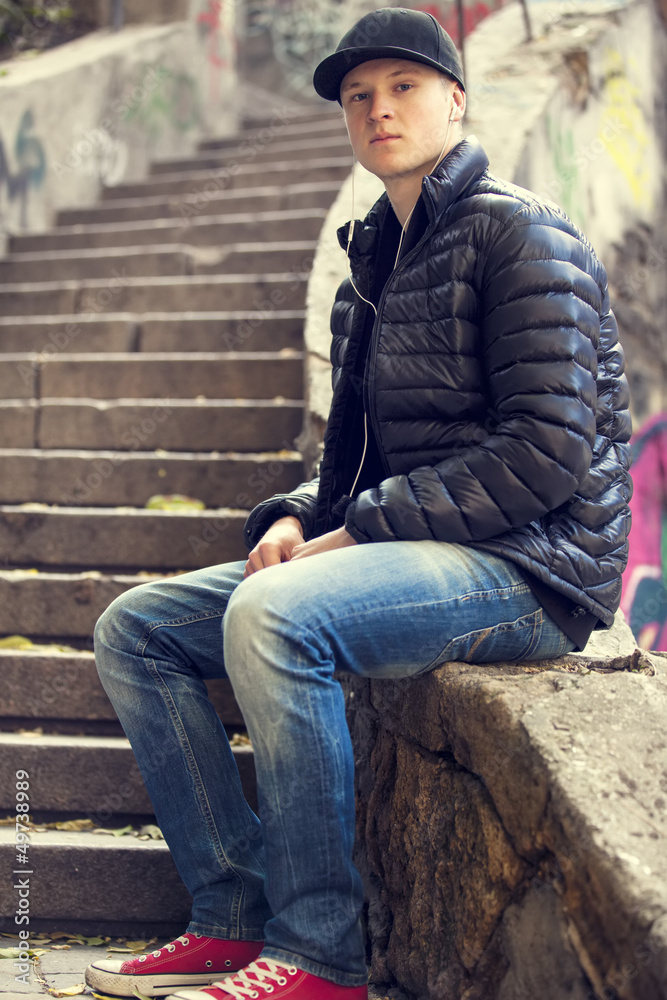 young man posing in front of a colorful graffiti stairs young man posing in front of a colorful graffiti stairs
