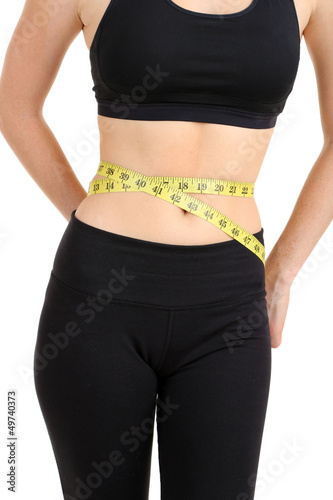 Woman measuring her waist isolated on white