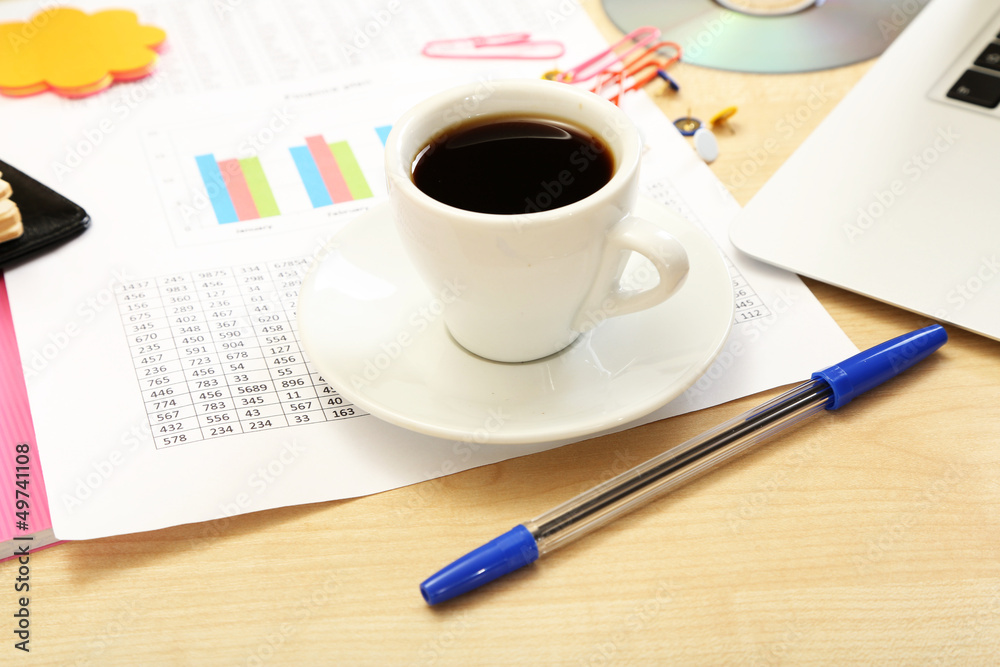 Cup of coffee on office desktop close-up