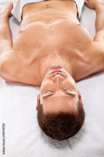 A young man is relaxing in spa center