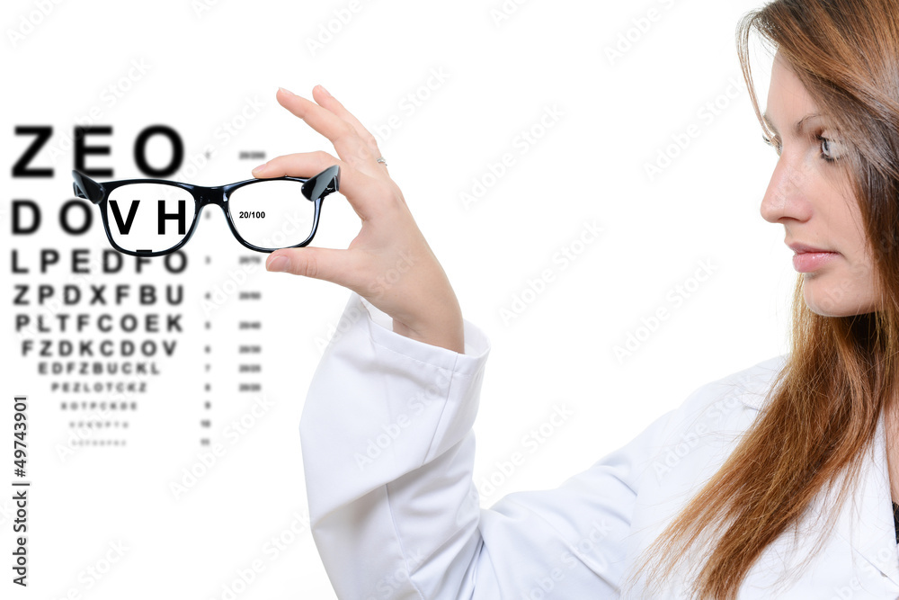 Optician giving a patient glasses to try on Optician giving a patient glasses to try on
