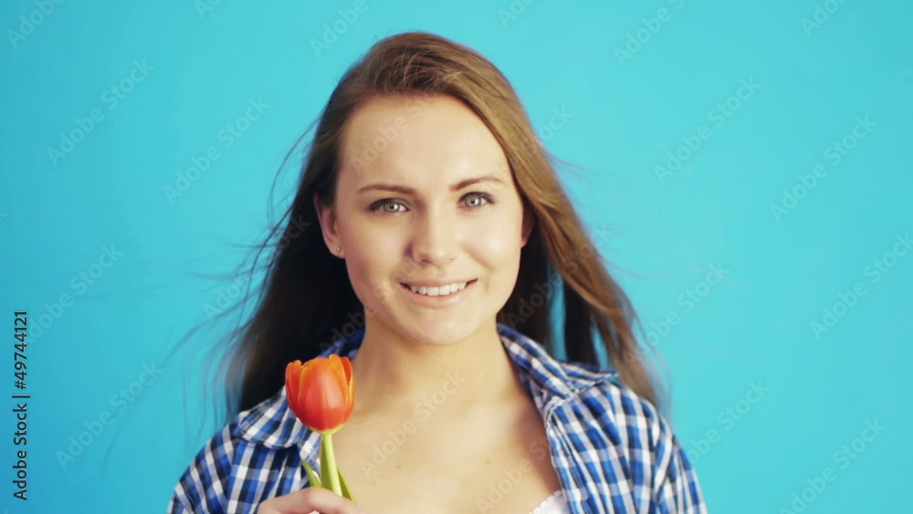 beautiful young woman sniffing red tulip beautiful young woman sniffing red tulip