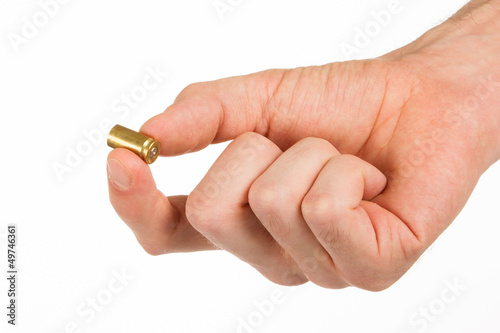 Hand holding an empty bullet shell