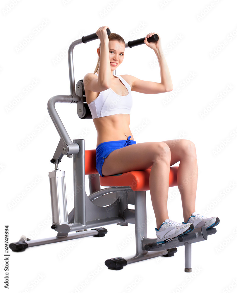 Fototapeta premium Sporty woman doing exercises on trainer