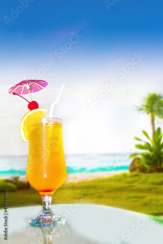 glass of fresh juice on sea background