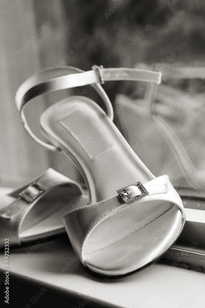 Bridal shoes at window in black and white