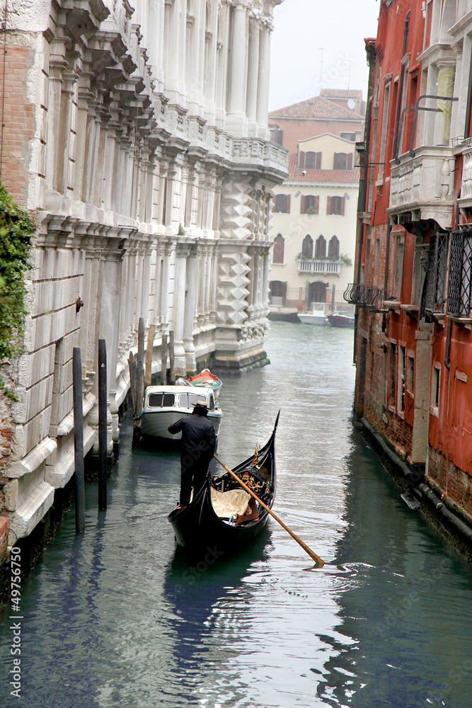 Venice with gondolas on  canal in Italy