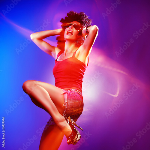 Beautiful woman with afro haircut is dancing disco.