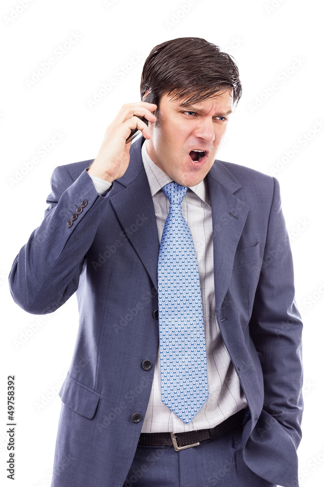 Angry businessman speaking on mobile phone and shouting Angry businessman speaking on mobile phone and shouting