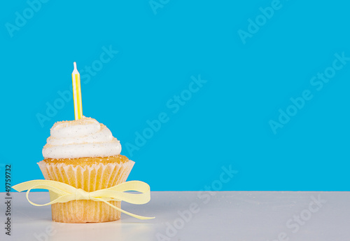 Single cupcake with yellow candle
