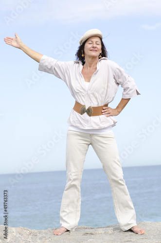 Relaxed mature woman ocean background