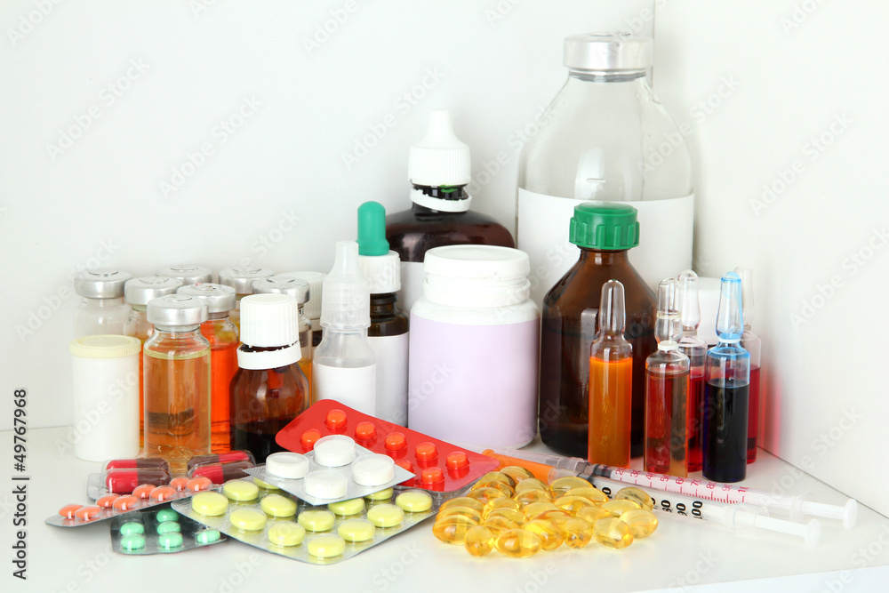 Medical bottles and pills on shelf