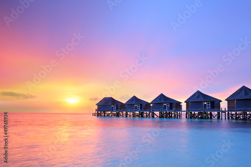 Sunset on Maldives island, water villas resort photo