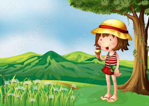A girl eating an icecream at the top of the hills