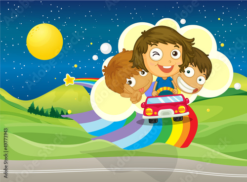 Three kids riding on a car passing over the rainbow