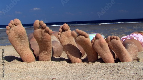 Feet on beach sea.