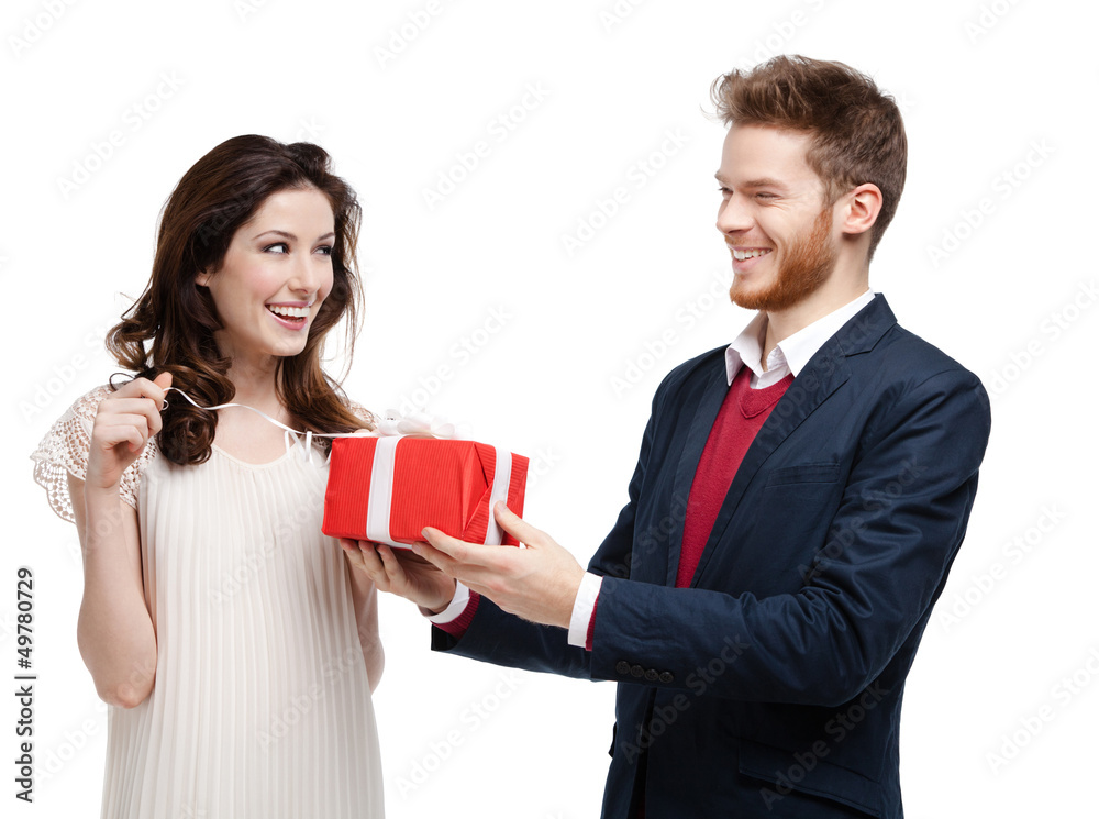Man gives present wrapped in red paper to his girlfriend Man gives present wrapped in red paper to his girlfriend