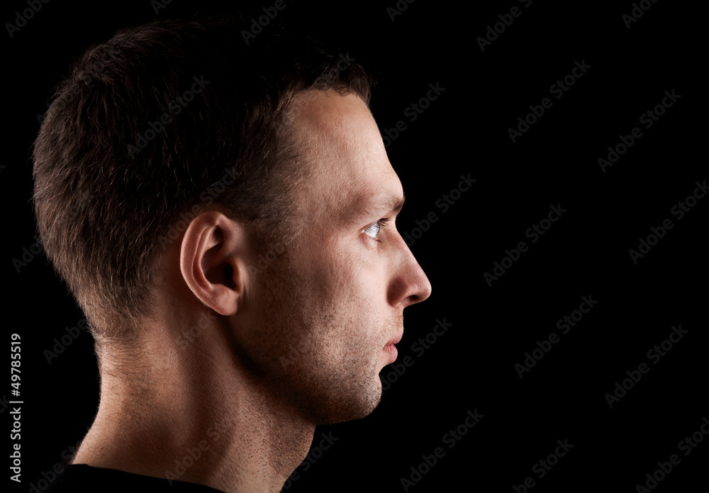 Profile portrait of young man isolated on black Profile portrait of young man isolated on black