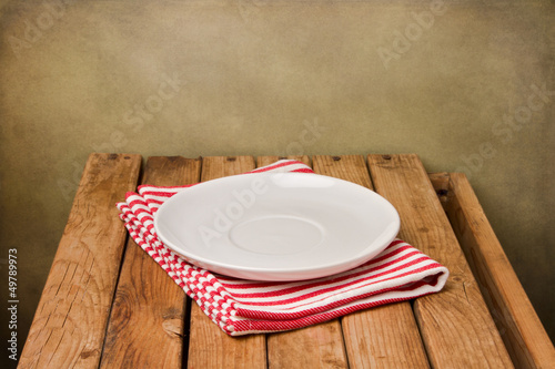 Background with empty plate and wooden table