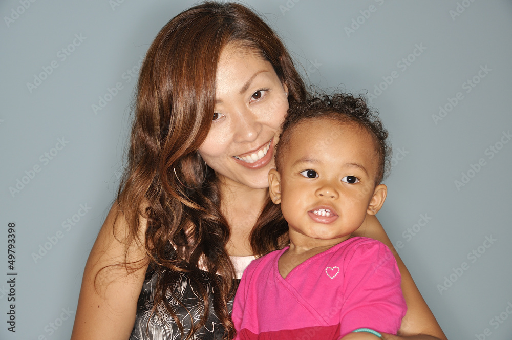 Asian mother posing with her mixed race infant daughter Asian mother posing with her mixed race infant daughter