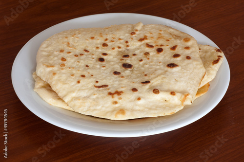 Stack of flour tortillas on plate