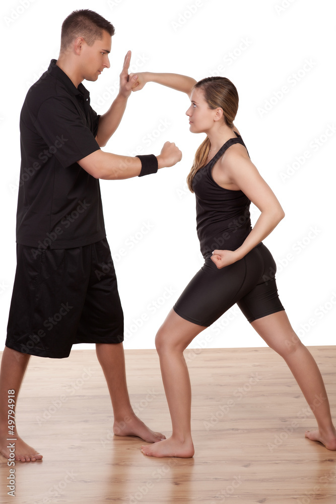 Obraz premium Woman and man practising kick boxing