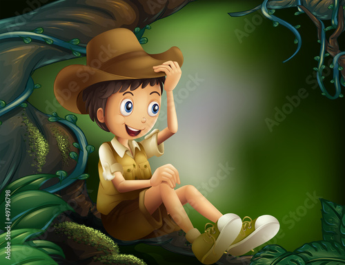 A boy sitting in a tree at the rainforest