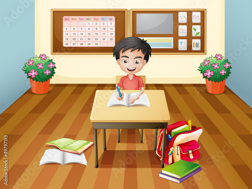 A boy writing at the table