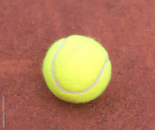 Tennis ball close up on red ground © EM Art