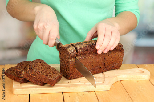 Woman slicing black bread