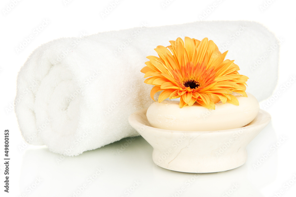 Rolled white towel, soap bar and beautiful flower isolated Rolled white towel, soap bar and beautiful flower isolated