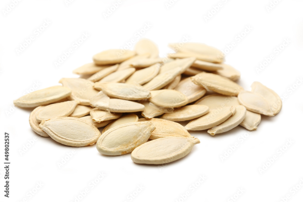 Pumpkin seeds on the white background Pumpkin seeds on the white background