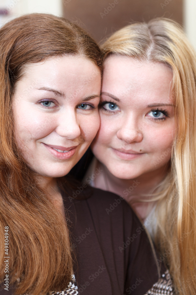 Two joyful Caucasian young women together looking at camera Two joyful Caucasian young women together looking at camera