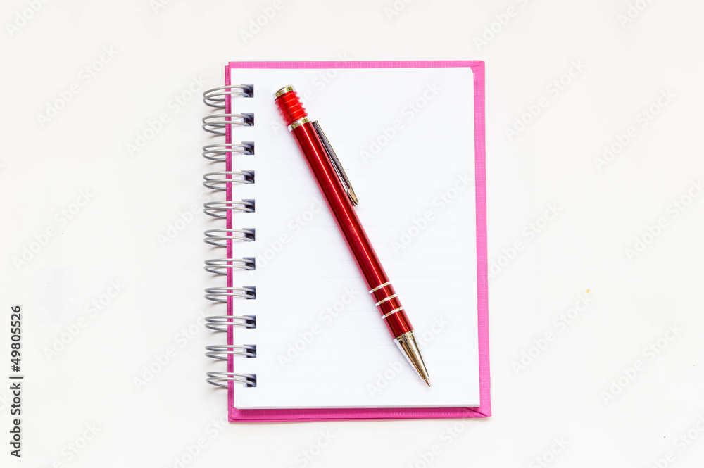 pink notebook with red pen on white background pink notebook with red pen on white background